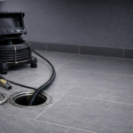 Professional drain cleaning equipment clearing a blocked floor drain in Whitehorse and Teslin Yukon